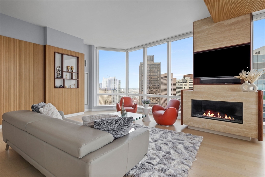 1 Franklin Street, Unit 3808 Boston, MA 02110 - Photo 7 of 40 a living room with furniture fireplace and flat screen tv