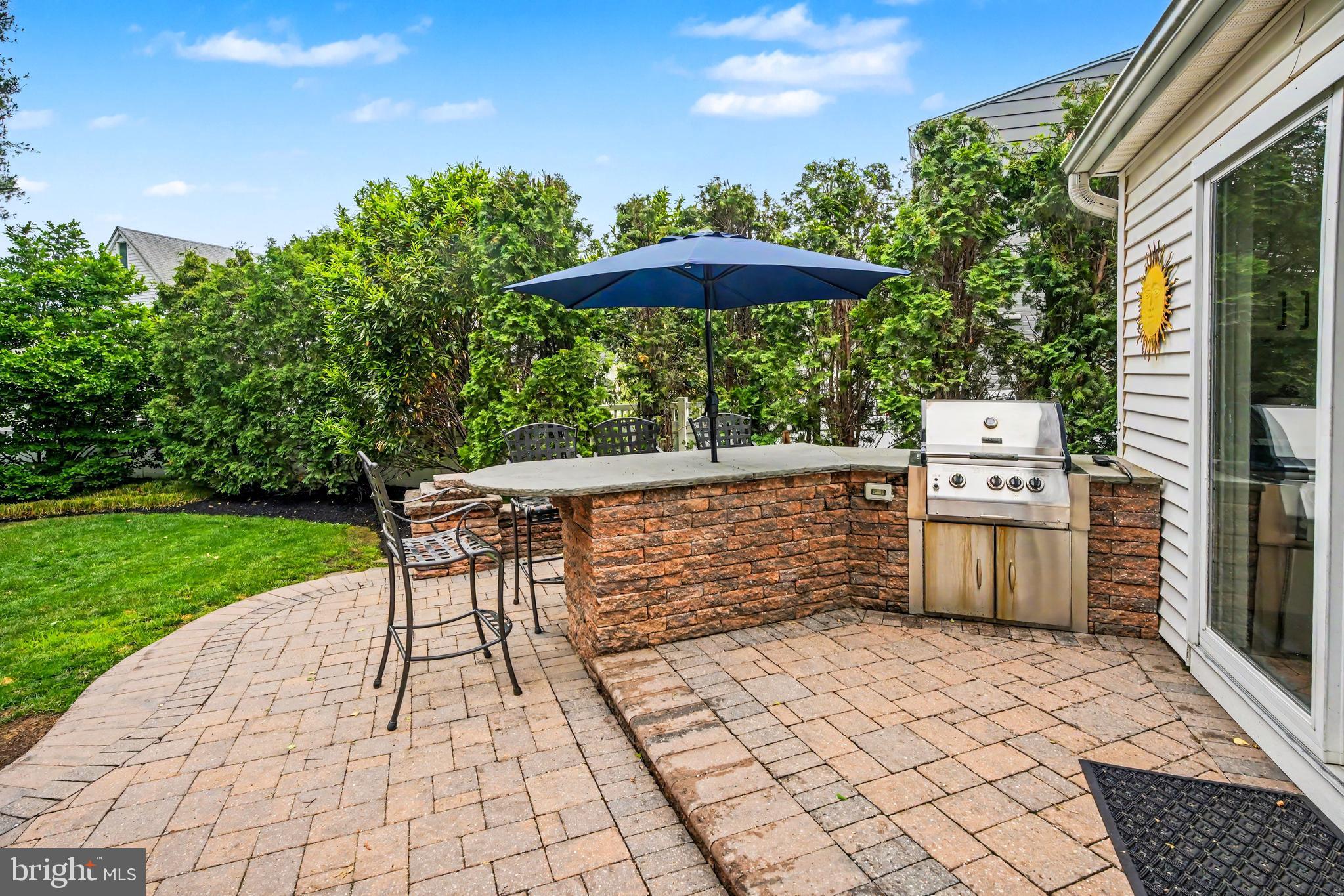 235 Hopkins Road Haddonfield, NJ 08033 - Photo 39 of 47 a view of a patio with a table and chairs under an umbrella