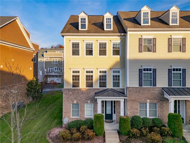 a front view of a residential apartment building with a yard