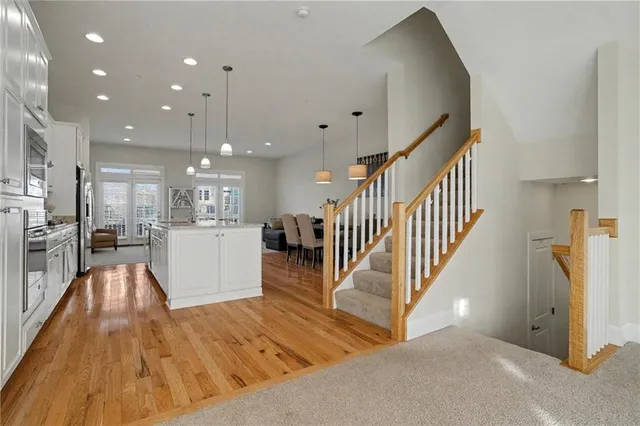 a view of a living room and kitchen with stainless steel appliances