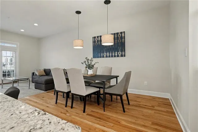 a dining room with furniture and wooden floor
