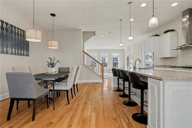 an open kitchen with dining table and chairs