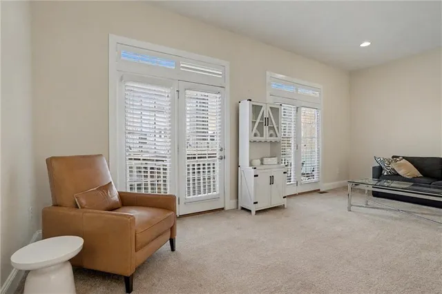 a living room with furniture and a floor to ceiling window