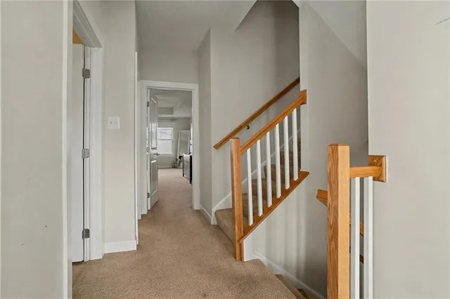a view of a hallway with wooden floor and entryway