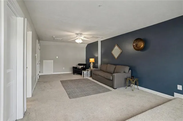a living room with furniture and a lamp