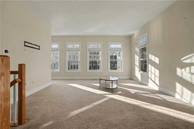 a living room with furniture and large windows