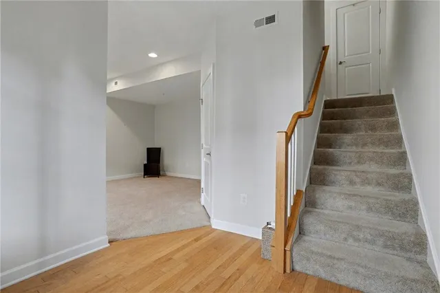 a view of entryway and hall with wooden floor