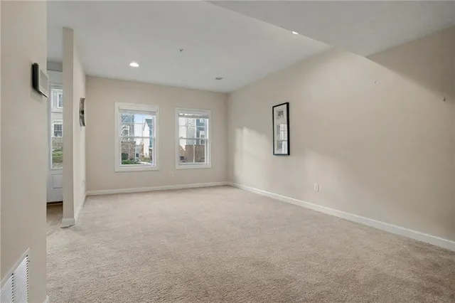 an empty room with windows and closet