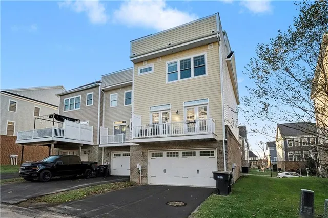 a car parked in front of a white house