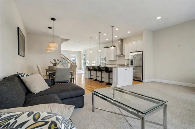 a living room with furniture and kitchen view