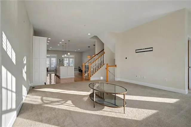a room with lots of furniture and white walls