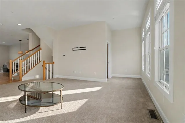 a view of a livingroom with furniture and staircase