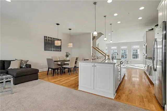 a living room with furniture and kitchen view