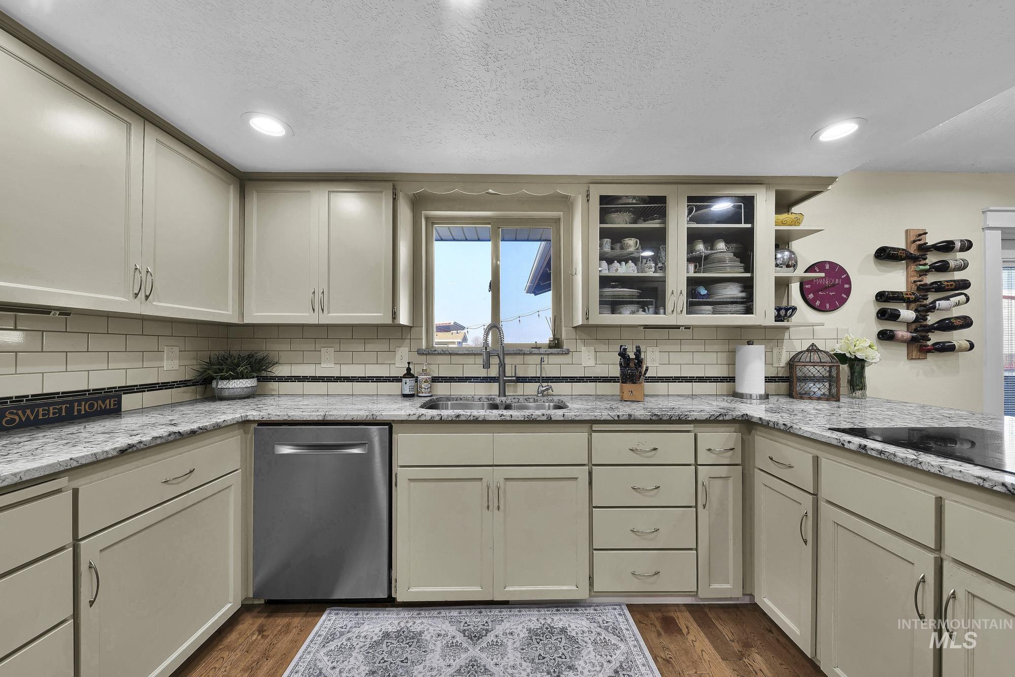 315 East Pat Lane Caldwell, ID 83607 - Photo 15 of 50 Kitchen featuring light granite countertops, stainless steel appliances, open shelves, hardwood flooring, and an induction cooktop