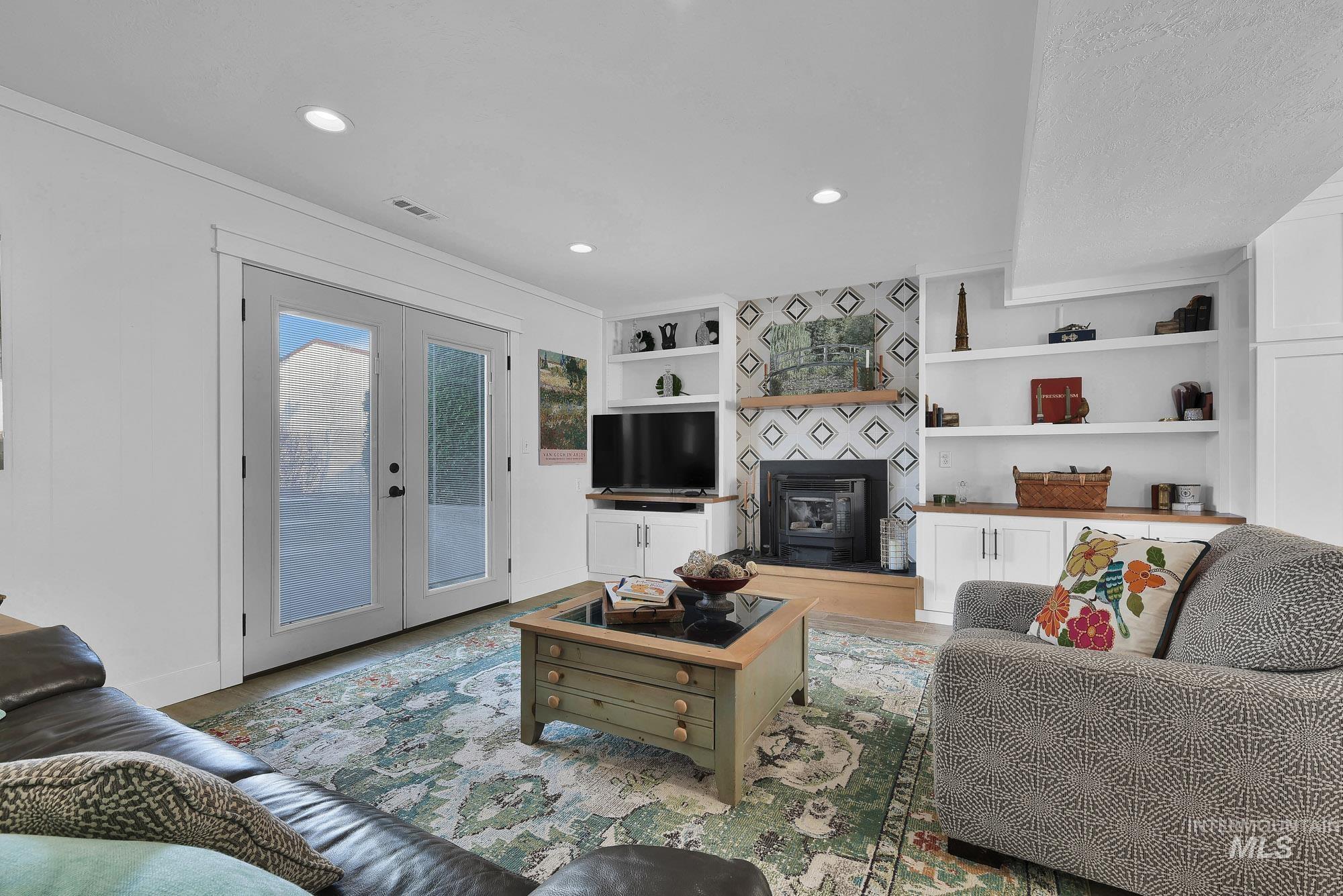 315 East Pat Lane Caldwell, ID 83607 - Photo 20 of 50 Family room with French door access to back patio area, built in features, recessed lighting, and crown molding