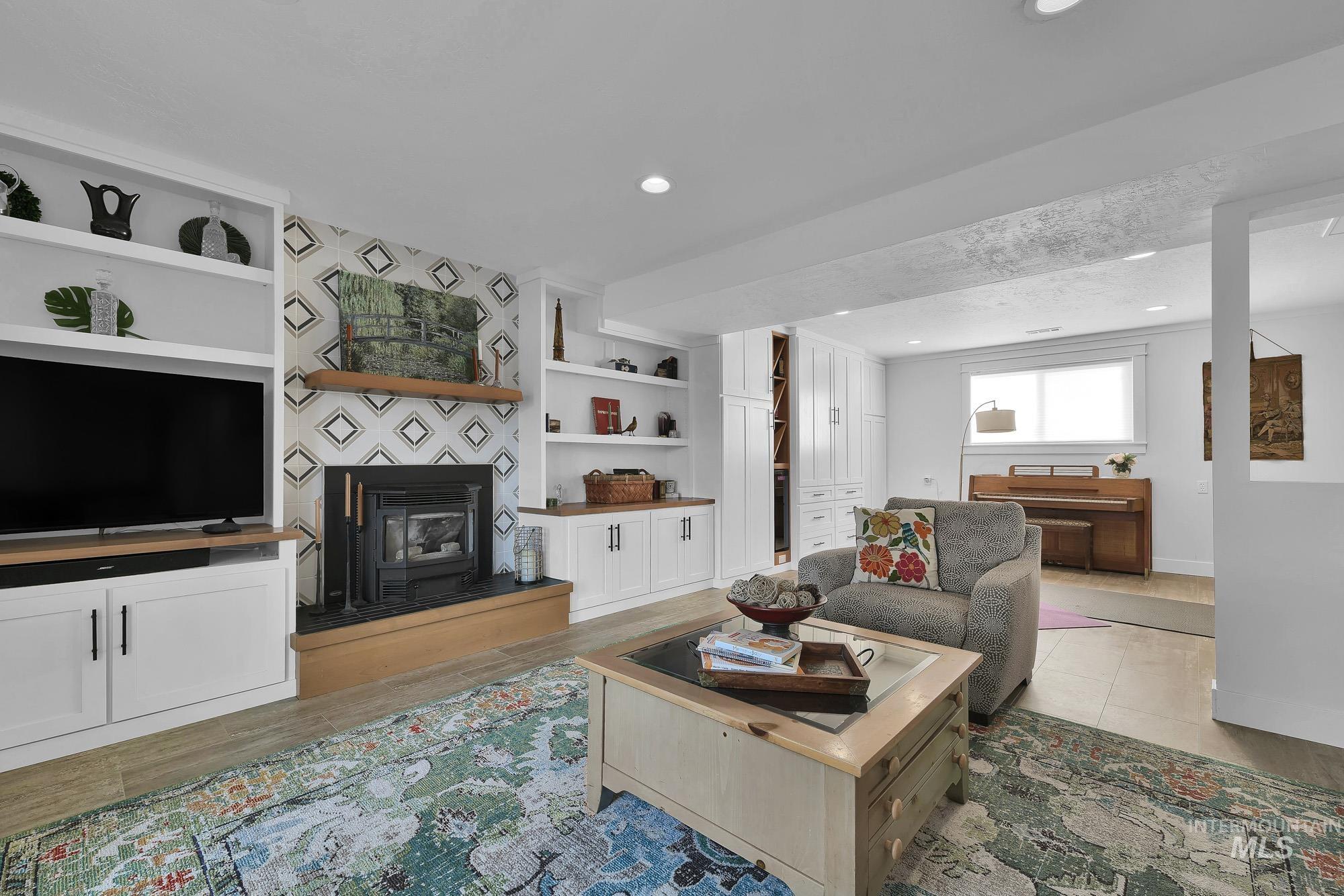 315 East Pat Lane Caldwell, ID 83607 - Photo 21 of 50 Living area featuring a fireplace, built in shelves, recessed lighting, and light wood-like LVP floors