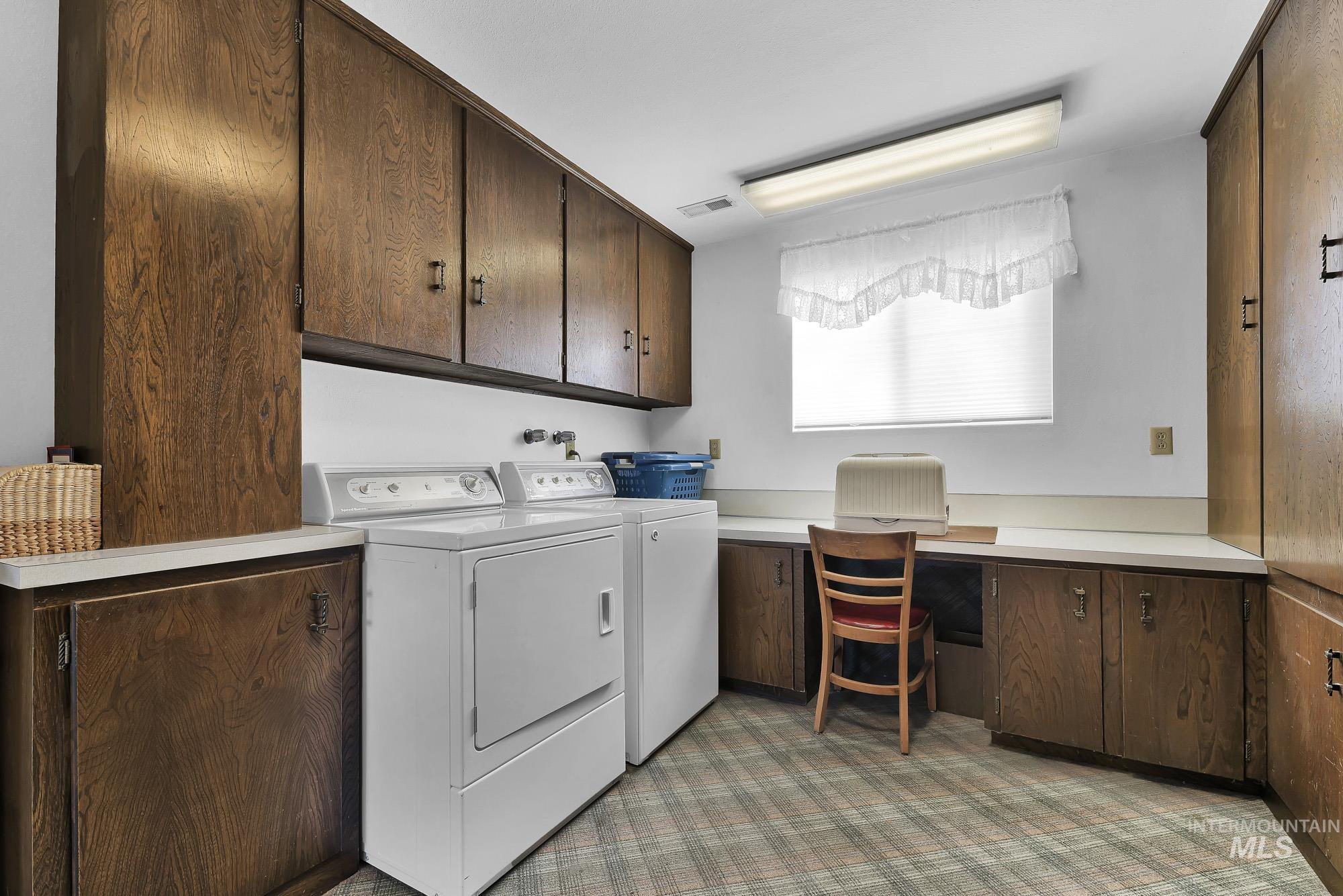 315 East Pat Lane Caldwell, ID 83607 - Photo 26 of 50 Laundry area with cabinet space, washer and clothes dryer, and craft area