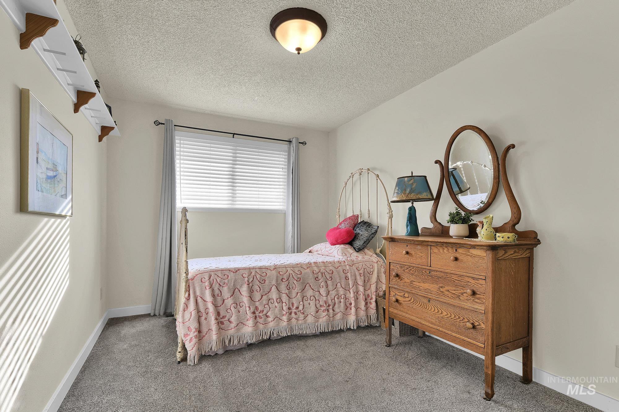 315 East Pat Lane Caldwell, ID 83607 - Photo 27 of 50 Bedroom featuring an upper display shelf and carpeted flooring