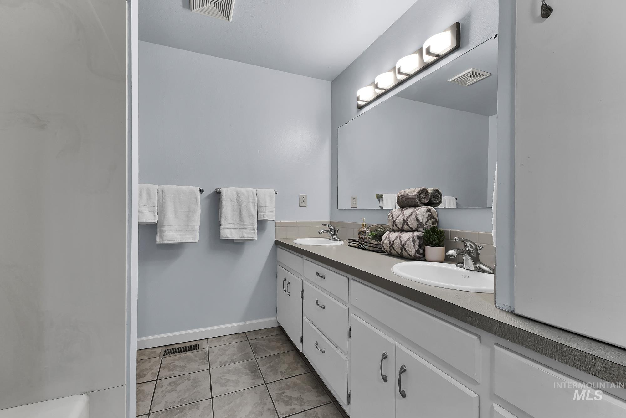 315 East Pat Lane Caldwell, ID 83607 - Photo 29 of 50 Bathroom with double vanities and light tile patterned floors