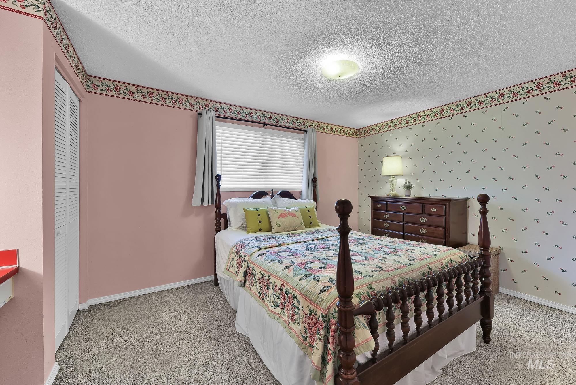 315 East Pat Lane Caldwell, ID 83607 - Photo 32 of 50 Bedroom featuring a built in desk area, neutral colors, a closet, and light colored carpet