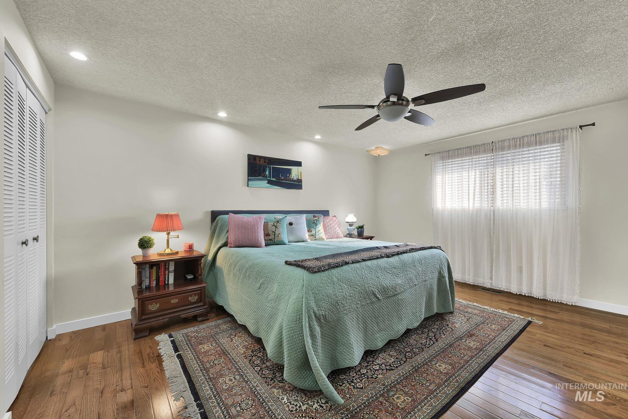 315 East Pat Lane Caldwell, ID 83607 - Photo 34 of 50 Primary Bedroom featuring hardwood flooring, double closets, ceiling fan, and recessed lighting