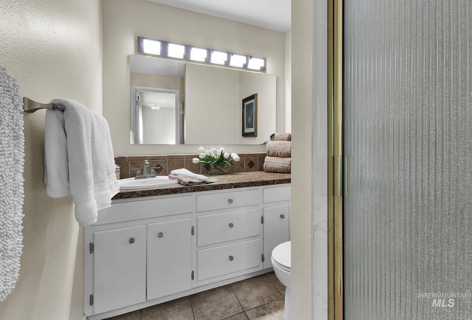 315 East Pat Lane Caldwell, ID 83607 - Photo 36 of 50 Primary Bathroom featuring large vanity, light tile patterned flooring, and walk in shower