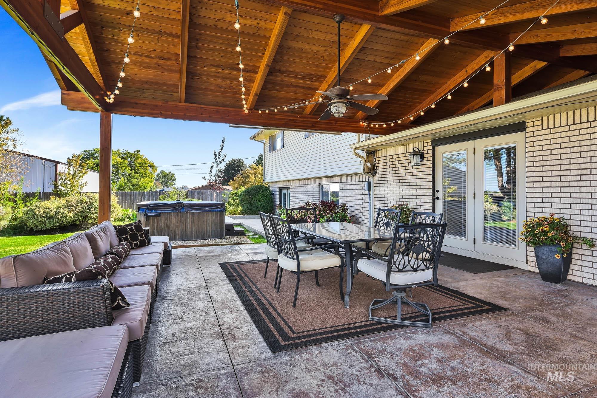 315 East Pat Lane Caldwell, ID 83607 - Photo 39 of 50 View of patio / terrace with a hot tub, outdoor dining space, ceiling fan, and an outdoor living space