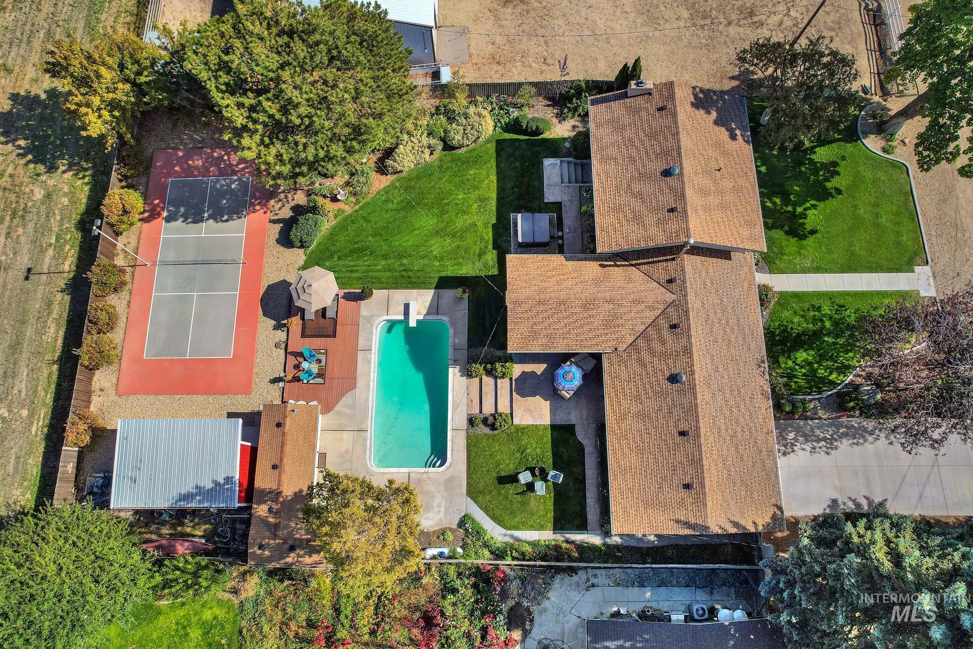 315 East Pat Lane Caldwell, ID 83607 - Photo 50 of 50 Bird's eye view of the house and acreage featuring the shop - pool house and pool area - and lighted pickle ball court