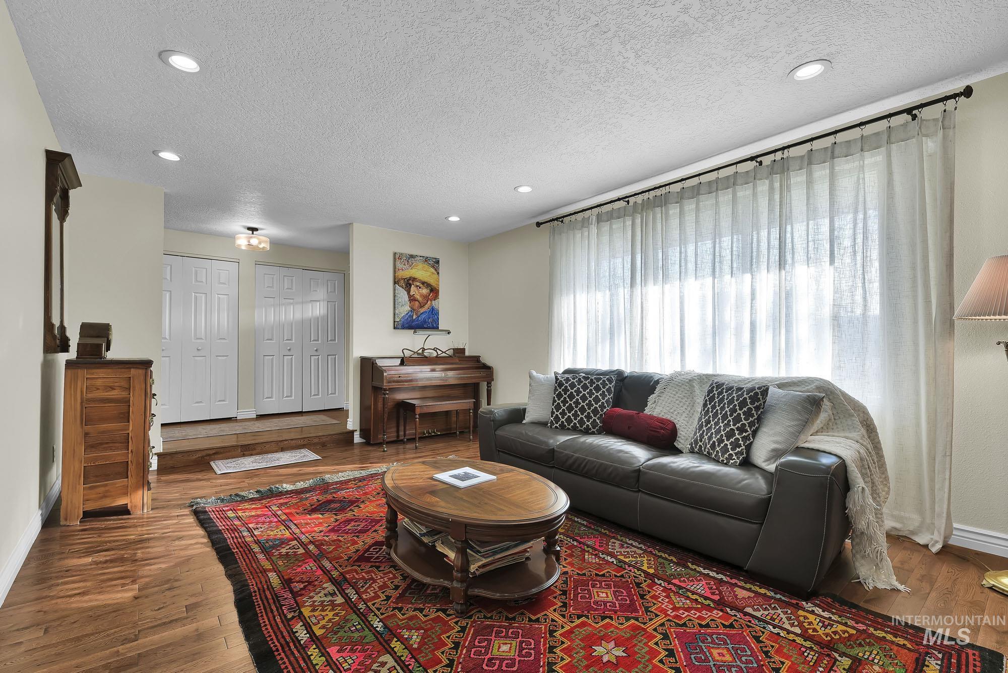 315 East Pat Lane Caldwell, ID 83607 - Photo 8 of 50 Living area featuring a textured ceiling, recessed lighting, and hardwood floors with huge picture window for natural light