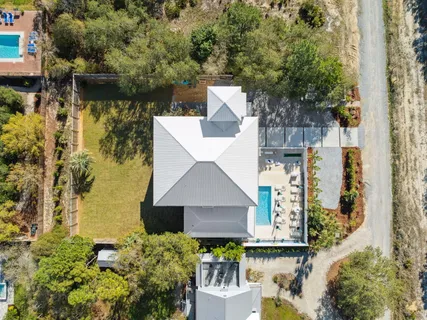 an aerial view of a house with a yard