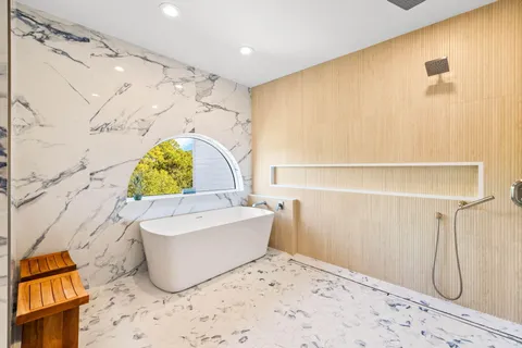 a living room with furniture a chandelier and a flat screen tv