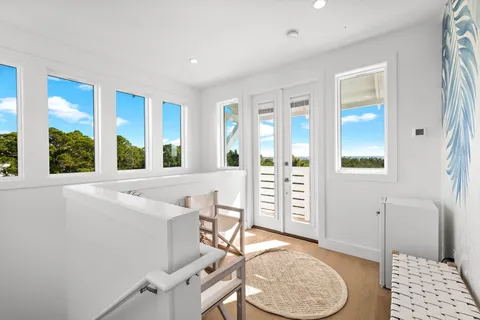 a kitchen with stainless steel appliances kitchen island granite countertop a dining table chairs and a refrigerator