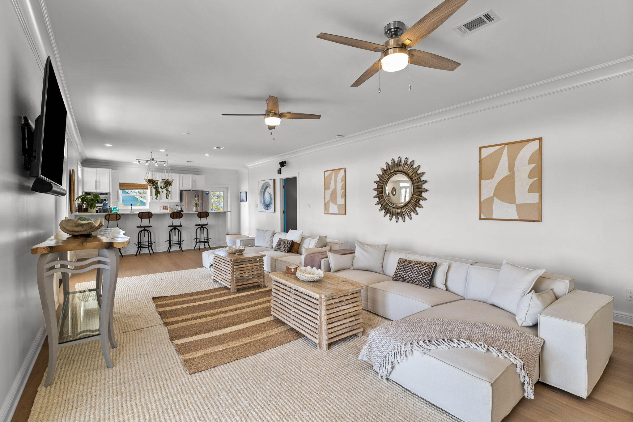 204 Sandstone Street Santa Rosa Beach, FL 32459 - Photo 28 of 80 a living room with furniture a chandelier and a flat screen tv