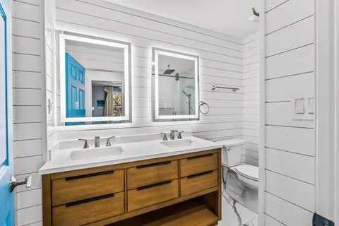 an aerial view of ocean and residential houses with outdoor space