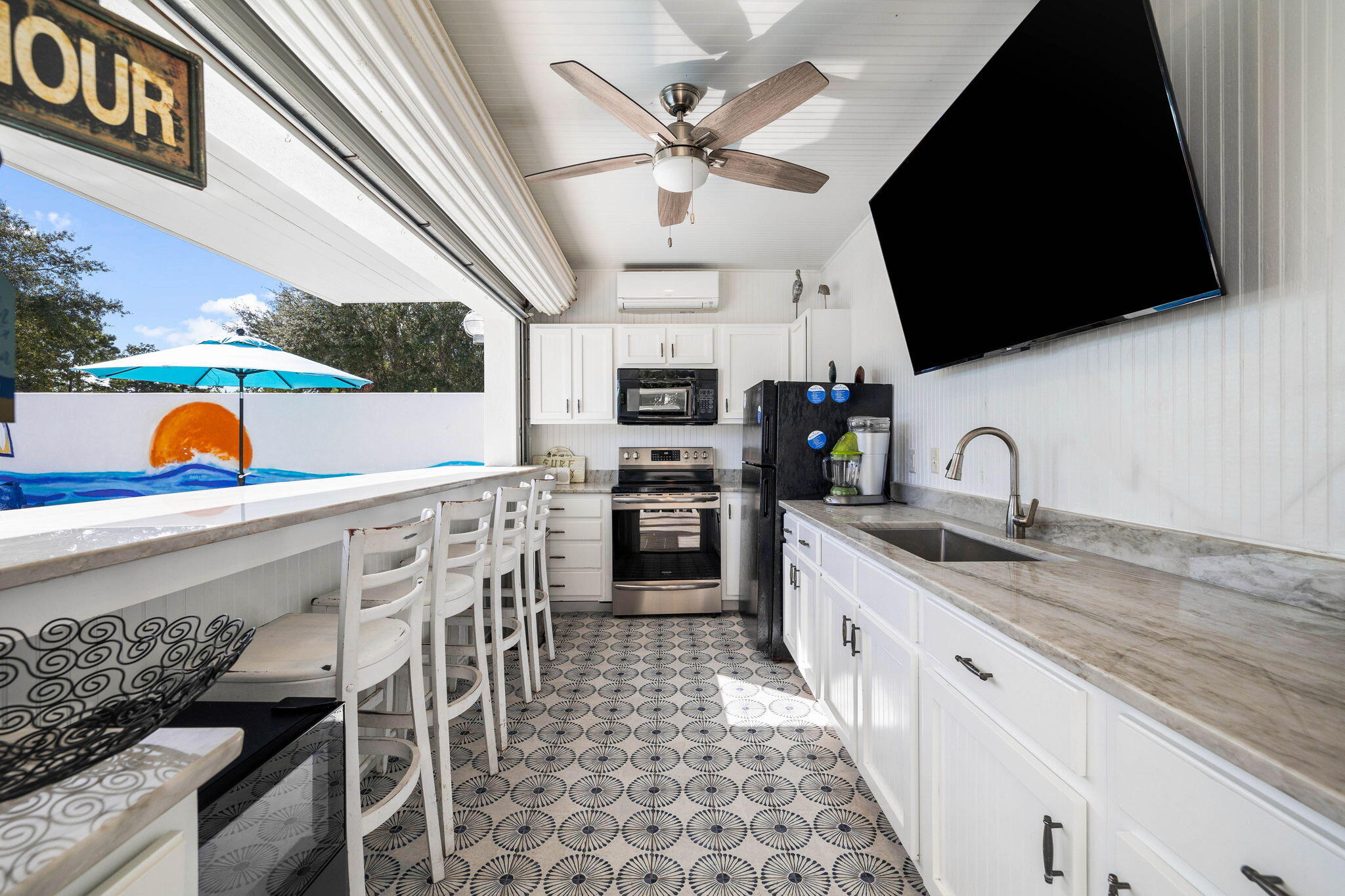204 Sandstone Street Santa Rosa Beach, FL 32459 - Photo 10 of 80 a kitchen with stainless steel appliances kitchen island granite countertop a sink a stove and a microwave oven