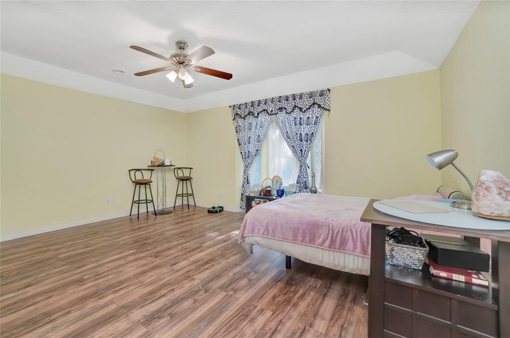 6021 Sycamore Creek Road Edgecliff Village, TX 76134 - Photo 18 of 37 Bedroom featuring wood finished floors, baseboards, and a ceiling fan