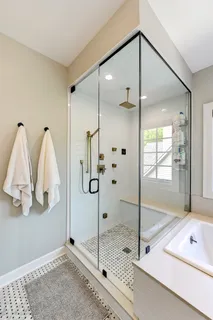 a bathroom with a shower and a tub