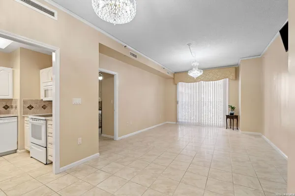 a view of a kitchen with a sink and a refrigerator
