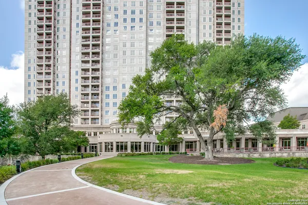 front view of a building with a garden
