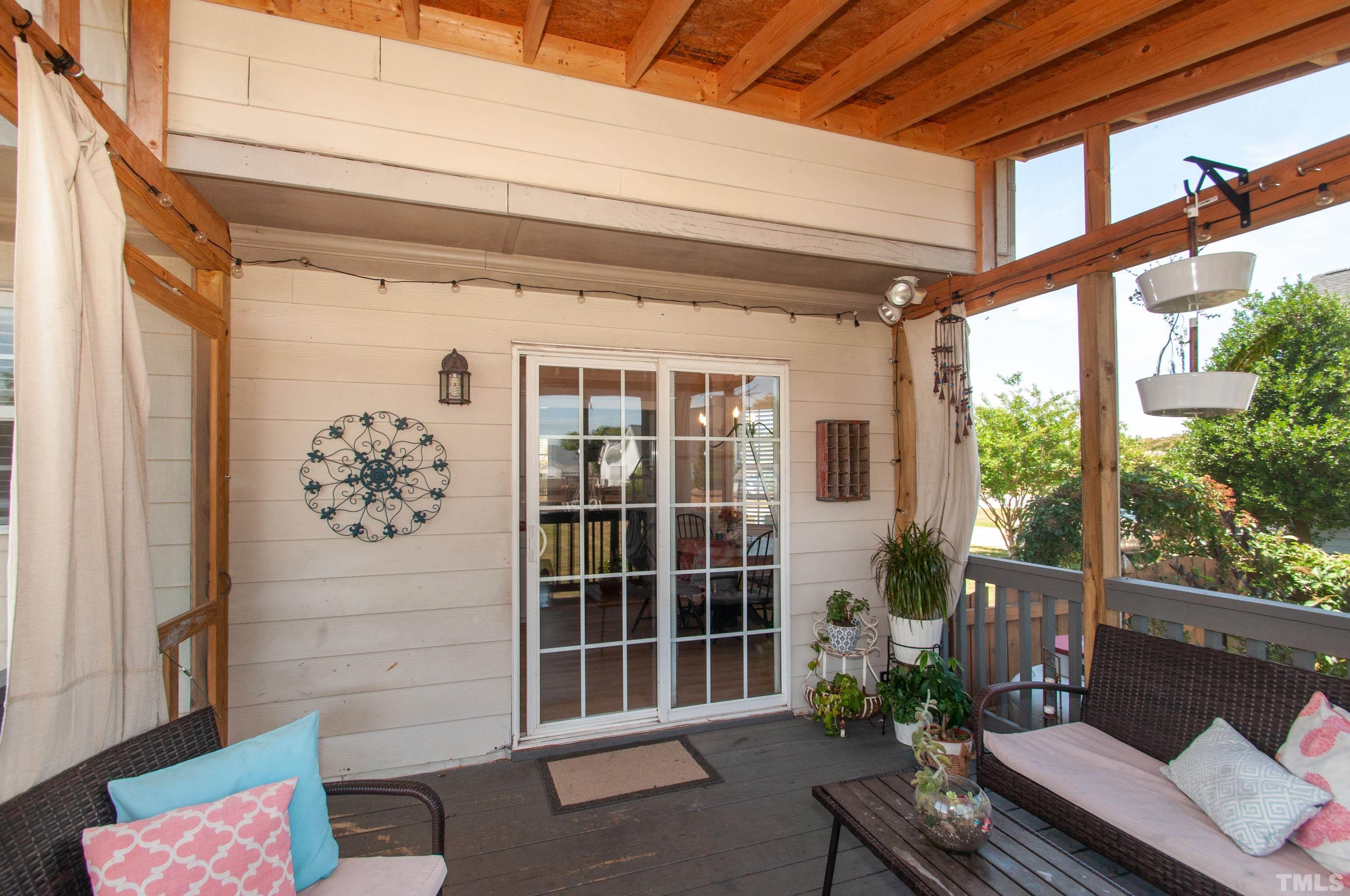 4805 Kure Road Raleigh, NC 27603 - Photo 19 of 31 a view of a porch with chairs and a potted plant