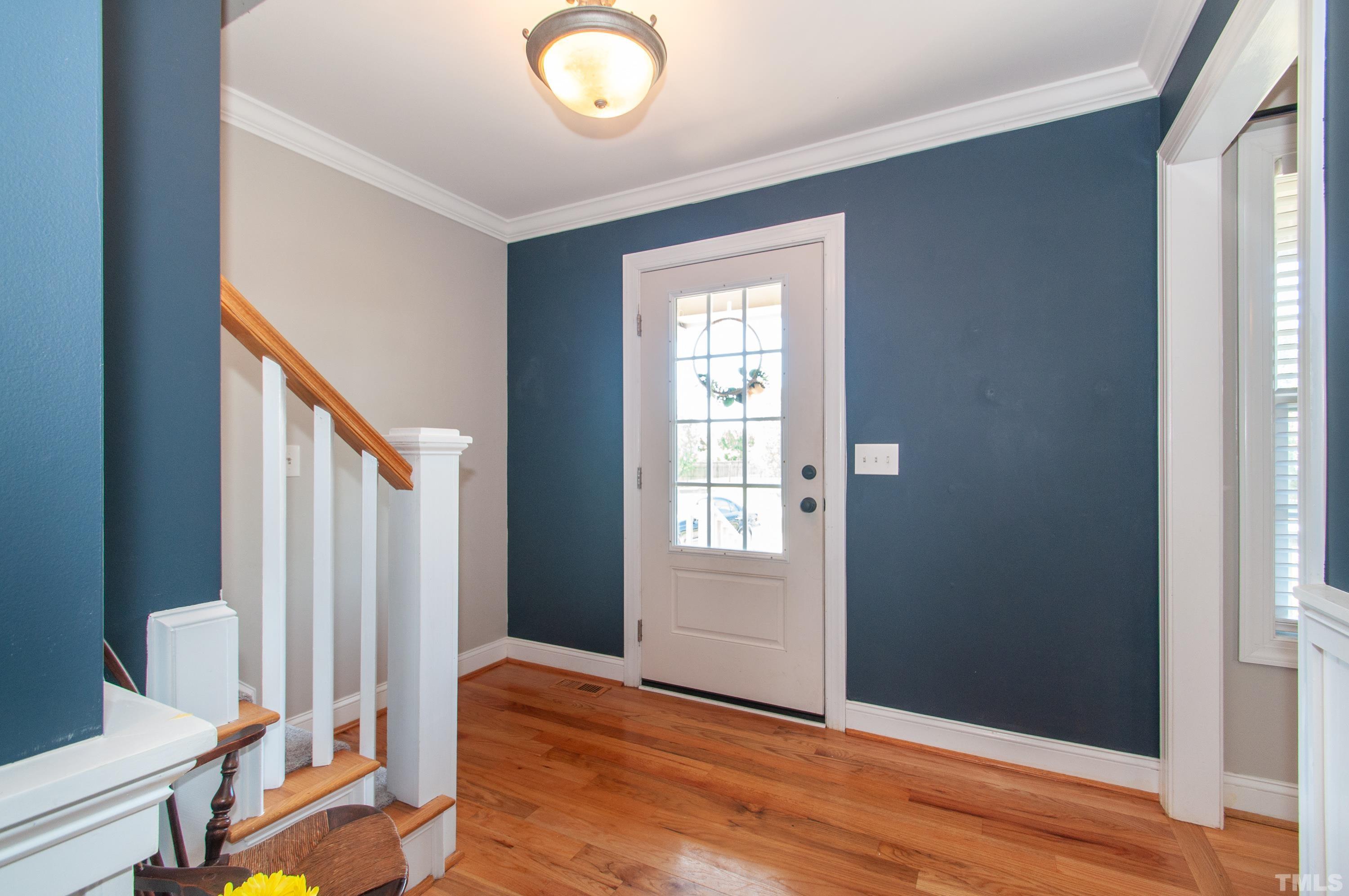 4805 Kure Road Raleigh, NC 27603 - Photo 3 of 31 an empty room with wooden floor and windows