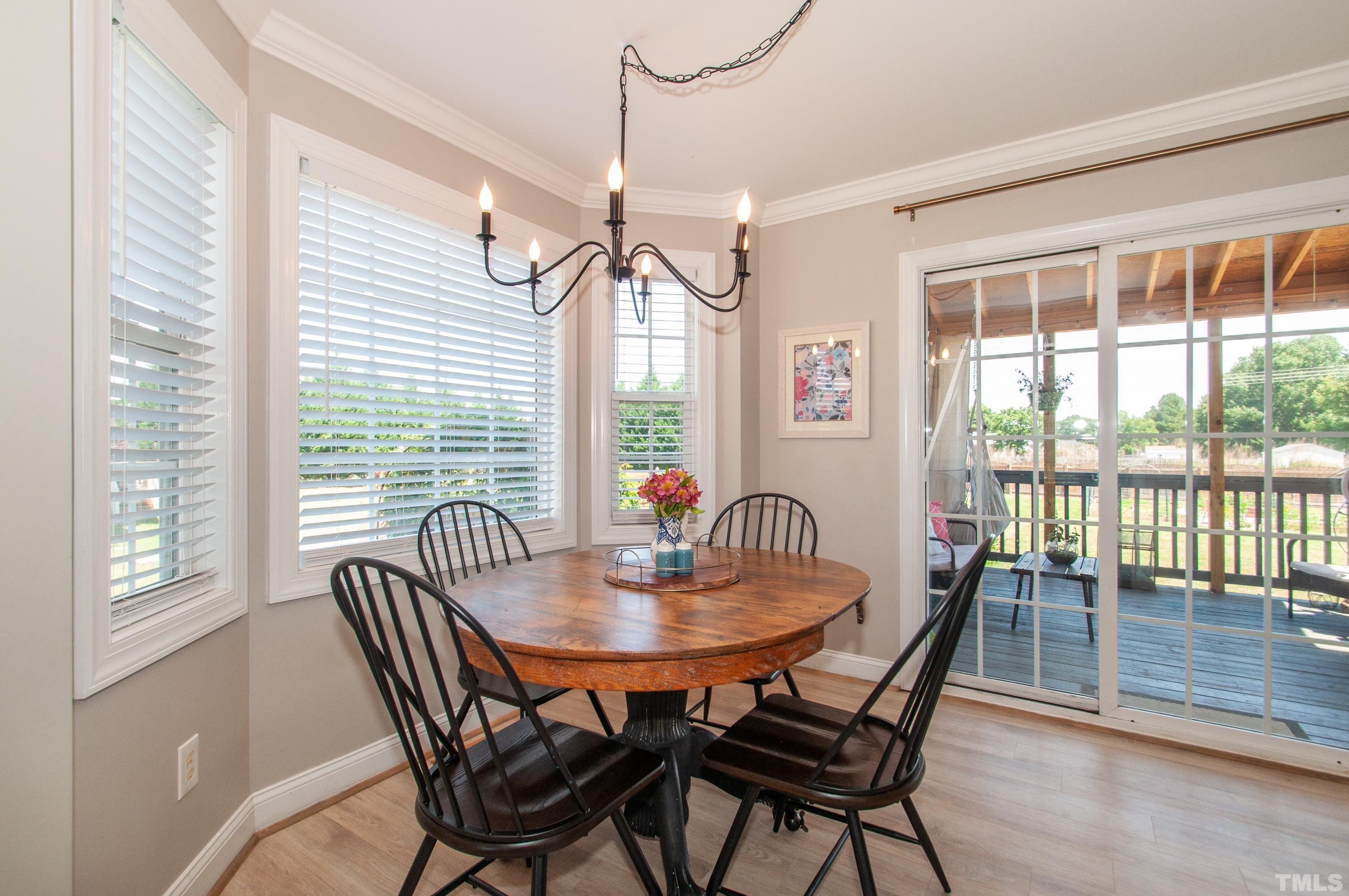 4805 Kure Road Raleigh, NC 27603 - Photo 6 of 31 a dining room with furniture window and wooden floor