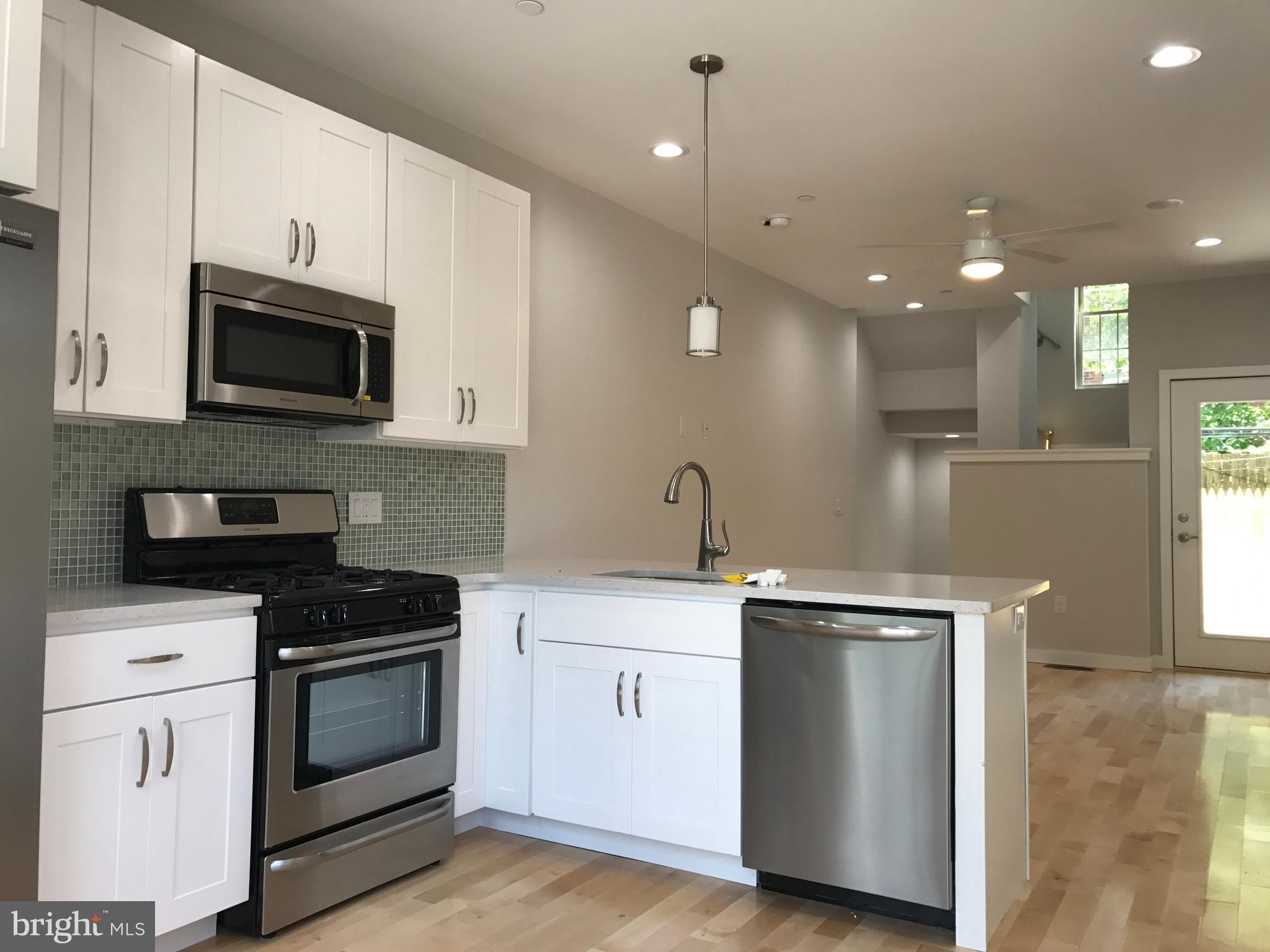 3726 Brandywine Street Philadelphia, PA 19104 - Photo 1 of 18 a kitchen with stainless steel appliances granite countertop a stove a sink and a microwave