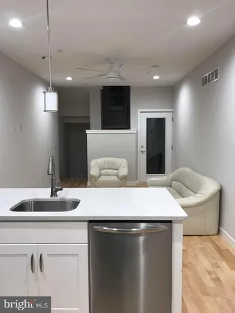 a kitchen with a sink and a refrigerator