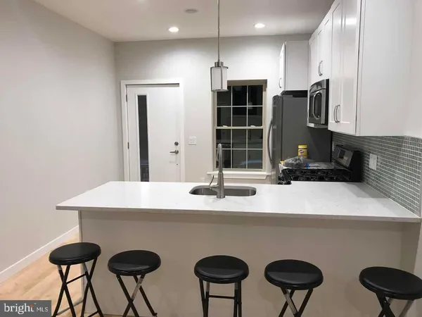 a kitchen with stainless steel appliances a sink and a refrigerator