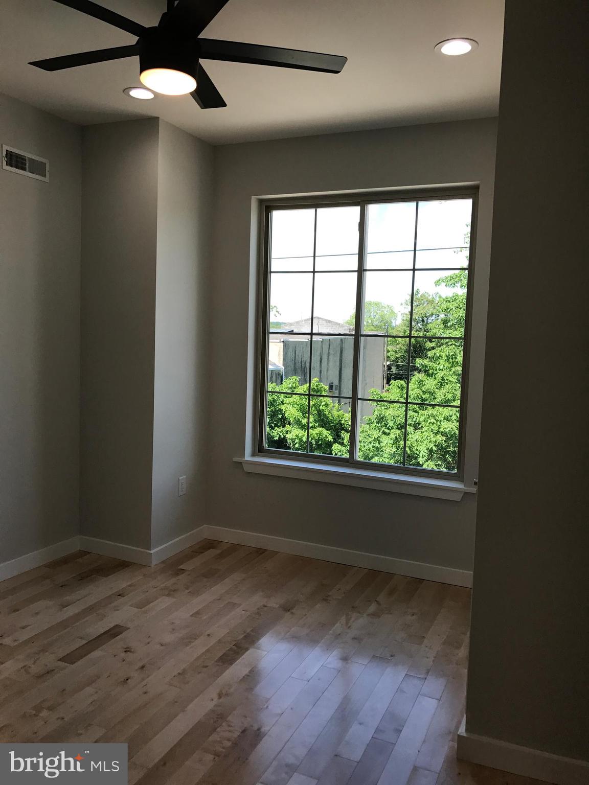 3726 Brandywine Street Philadelphia, PA 19104 - Photo 7 of 18 an empty room with wooden floor and windows