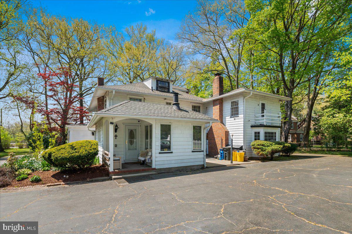 700 River Road Ewing, NJ 08628 - Photo 54 of 71 a view of a white house with large windows and a large tree