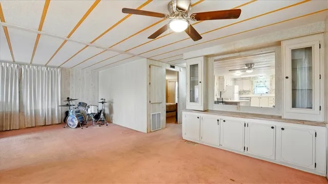 a living room with furniture a window and gym equipment