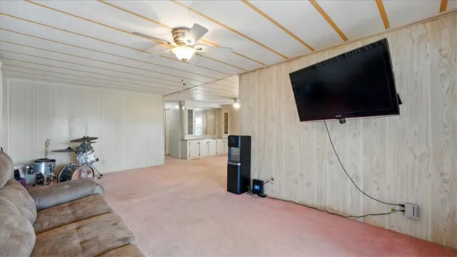 a bedroom with a bed and large window