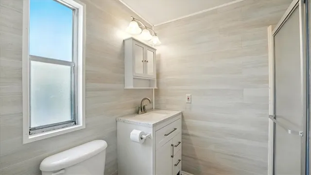 a spacious bathroom with a window and a shower